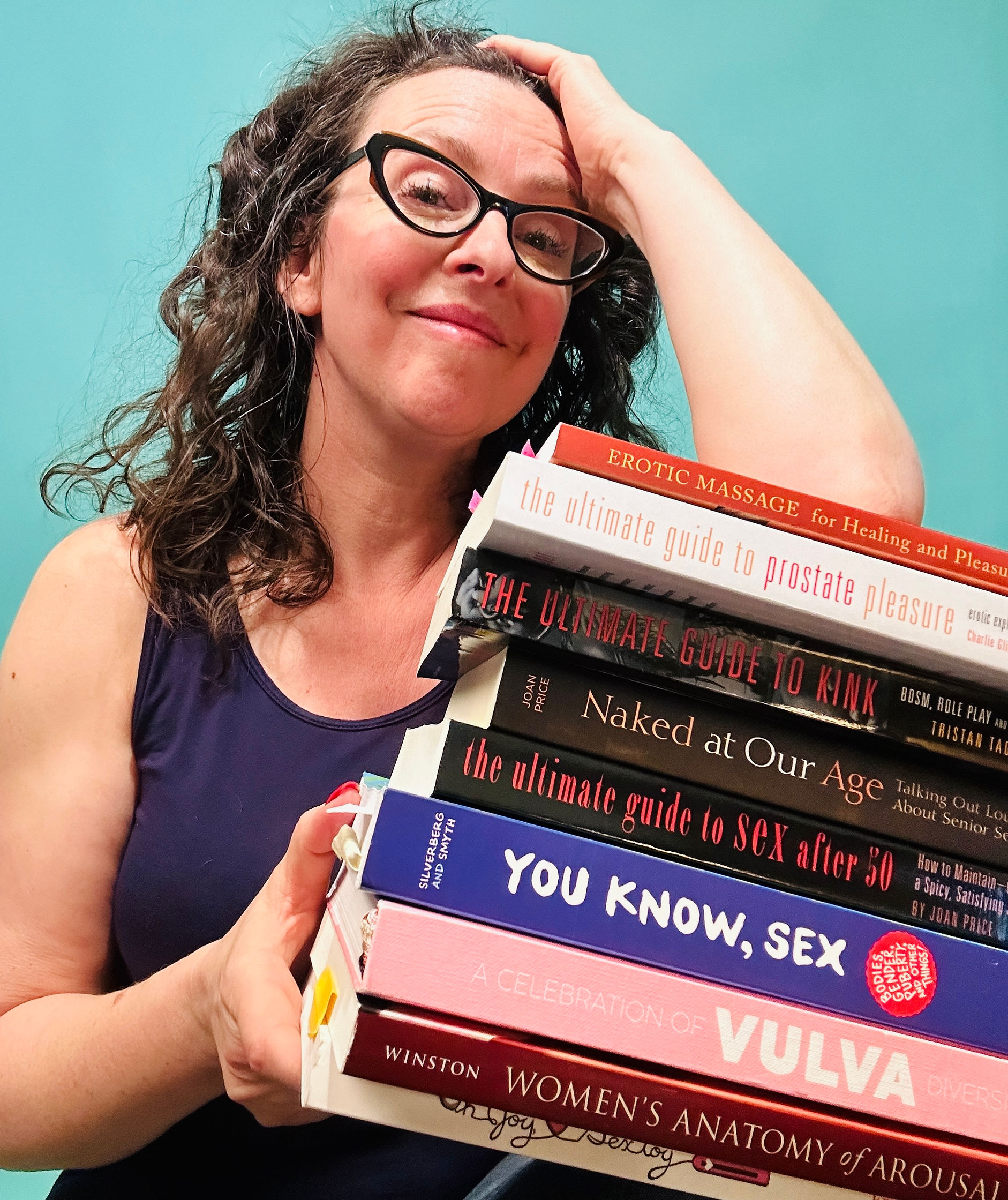 gretel holding a stack of sex education books