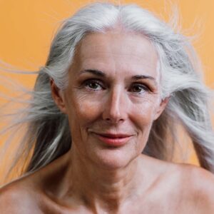 older grey haired women with hair blowing in wind